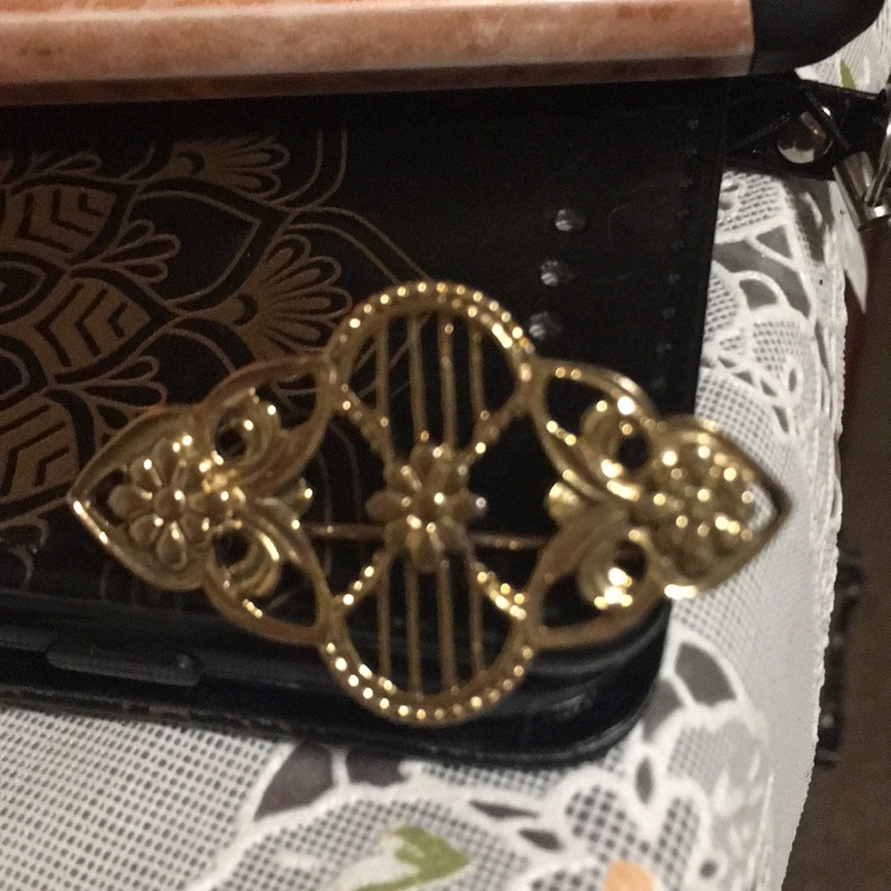 Gold tone brooch.